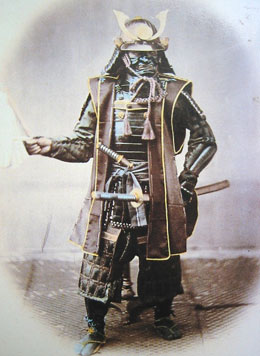 a hand-coloured  photography of a man in samurai amrour